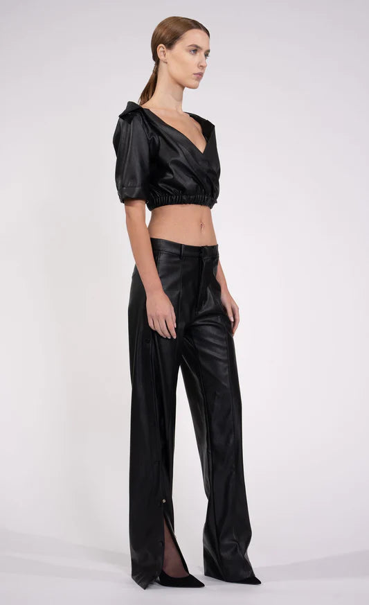 Kate Top by Nonchalant | Introducing the Kate Top, your ultimate wardrobe essential for injecting a dose of bold flair. This leather off-the-shoulder crop effortlessly combines sophistication with a hint of daring style. Crafted with an elasticized waistband to ensure an impeccable fit, the Kate Top is your go-to choice. Pair with the matching Julia Pant. 100% PU Leather True To Size Model Wears XS Model Height 5'9 | Alene Too located in Boca Raton, FL